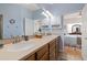 Bathroom with double sinks, lots of storage, and a view of the bedroom at 26622 Bull Run, Leesburg, FL 34748