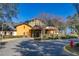Exterior of a well-maintained clubhouse with landscaped grounds and ample parking at 26622 Bull Run, Leesburg, FL 34748