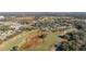 Wide aerial shot of a golf community, showcasing houses nestled among trees and golf fairways at 26622 Bull Run, Leesburg, FL 34748