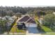 Charming one-story home with a manicured lawn, mature trees, and a two-car garage at 26622 Bull Run, Leesburg, FL 34748