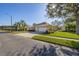 Street view of a home with manicured lawns, landscaping, and a three-car garage, offering convenience and curb appeal at 26622 Bull Run, Leesburg, FL 34748