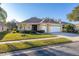 Inviting home featuring a manicured lawn, a two-car garage, and a neatly landscaped front yard at 26622 Bull Run, Leesburg, FL 34748