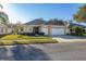 Charming home with a well-maintained lawn, a two-car garage, and an inviting entrance at 26622 Bull Run, Leesburg, FL 34748