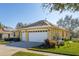This charming home boasts a spacious two-car garage, beautiful lawn, and solar panels at 26622 Bull Run, Leesburg, FL 34748