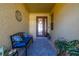 Inviting front porch featuring a bench with blue cushions and a decorative front door at 26622 Bull Run, Leesburg, FL 34748