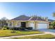 Charming single-story home with a well-manicured lawn, lush landscaping, and a spacious three-car garage at 26622 Bull Run, Leesburg, FL 34748