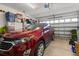 Garage interior with a red car and storage at 26622 Bull Run, Leesburg, FL 34748