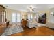 Inviting living room featuring a fireplace, hardwood floors, and natural light from patio doors at 26622 Bull Run, Leesburg, FL 34748