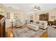 Spacious living room with hardwood floors, comfortable seating, and a view of the foyer at 26622 Bull Run, Leesburg, FL 34748