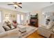 Bright living room featuring a fireplace, comfortable seating, and hardwood floors at 26622 Bull Run, Leesburg, FL 34748