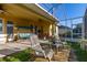 Covered patio with comfortable seating, perfect for enjoying outdoor living and backyard relaxation at 26622 Bull Run, Leesburg, FL 34748