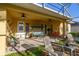 Spacious covered patio offering a swing, seating area and ceiling fans for a comfortable outdoor experience at 26622 Bull Run, Leesburg, FL 34748