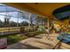 A screened porch with comfortable seating and views of the green landscape at 26622 Bull Run, Leesburg, FL 34748