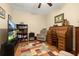 Cozy study with a roll-top desk, bookshelf, comfortable chair, and natural light at 26622 Bull Run, Leesburg, FL 34748