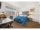 Comfortable bedroom with a queen bed, workspace, and ample natural light at 2713 Roadster Ln, Kissimmee, FL 34746