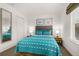 Bedroom with a queen bed, dresser, and large mirror at 2713 Roadster Ln, Kissimmee, FL 34746