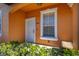 White front door and window with orange exterior at 2713 Roadster Ln, Kissimmee, FL 34746