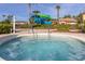 Relaxing hot tub with surrounding patio and palm trees at 2713 Roadster Ln, Kissimmee, FL 34746