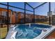 Hot tub in screened patio with seating area at 2713 Roadster Ln, Kissimmee, FL 34746