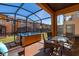Hot tub in screened patio with seating area at 2713 Roadster Ln, Kissimmee, FL 34746