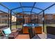 Hot tub in screened patio with seating area at 2713 Roadster Ln, Kissimmee, FL 34746