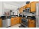 Updated kitchen with stainless steel appliances and wood cabinetry at 2713 Roadster Ln, Kissimmee, FL 34746