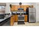 Well-equipped kitchen with stainless steel appliances and wood cabinets at 2713 Roadster Ln, Kissimmee, FL 34746