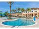 Large freeform pool with surrounding lounge chairs at 2713 Roadster Ln, Kissimmee, FL 34746