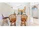 Kitchen with breakfast bar and view into the adjacent dining area at 303 Cherokee Ave, Haines City, FL 33844