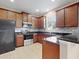 Modern kitchen featuring dark wood cabinets and granite countertops at 3109 Harris Park Way, Kissimmee, FL 34758