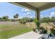 Covered patio with potted plants and a view of the fenced backyard at 362 Alexzander Way, Winter Haven, FL 33881