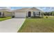 One-story house with a two-car garage and landscaped lawn at 362 Alexzander Way, Winter Haven, FL 33881