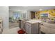 Open concept kitchen with island, stainless steel appliances, and views into dining area at 362 Alexzander Way, Winter Haven, FL 33881