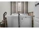 Laundry room with washer, dryer, and wood-look wall at 362 Alexzander Way, Winter Haven, FL 33881