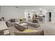 Spacious living room featuring a large sectional sofa and a modern coffee table at 362 Alexzander Way, Winter Haven, FL 33881
