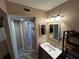 Updated bathroom with a contemporary vanity, mirror, and convenient storage shelving unit at 3984 Atrium Dr # 4, Orlando, FL 32822