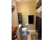 Cozy bathroom with updated vanity and tile flooring, and an organized shelving unit at 3984 Atrium Dr # 4, Orlando, FL 32822