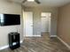 Spacious bedroom featuring a mounted TV and entry to a large walk-in closet at 3984 Atrium Dr # 4, Orlando, FL 32822