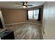 Well-lit bedroom features wood-look flooring, ceiling fan, and a window for natural light at 3984 Atrium Dr # 4, Orlando, FL 32822