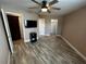 Bedroom with wood-look floors, TV, and access to closet and bathroom at 3984 Atrium Dr # 4, Orlando, FL 32822