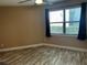 Bright bedroom with wood-look floors and large window at 3984 Atrium Dr # 4, Orlando, FL 32822