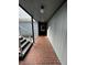 View down a building hallway with brick flooring and gray walls at 3984 Atrium Dr # 4, Orlando, FL 32822