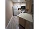 Galley kitchen with white appliances and cabinetry at 3984 Atrium Dr # 4, Orlando, FL 32822