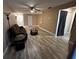 Living room features wood-look floors and a comfortable reclining sofa at 3984 Atrium Dr # 4, Orlando, FL 32822