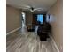 Spacious living room with wood-look floors and sliding glass doors at 3984 Atrium Dr # 4, Orlando, FL 32822