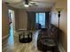 Bright living room with wood-look floors and access to the patio at 3984 Atrium Dr # 4, Orlando, FL 32822