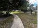 A walkway curves through a grassy area with trees at 3984 Atrium Dr # 4, Orlando, FL 32822