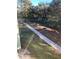 Pathway through a backyard with trees and a picnic table at 4372 Paradise Cove Ct, Kissimmee, FL 34746