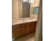 Double vanity bathroom with wood cabinets and a large mirror at 4372 Paradise Cove Ct, Kissimmee, FL 34746