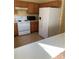 Kitchen features light countertops, wood cabinets, and white appliances at 4372 Paradise Cove Ct, Kissimmee, FL 34746